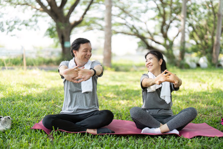 Couple sharing joyful moments during yoga practiceの写真素材