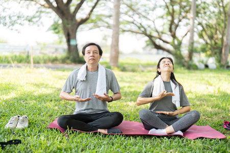 Couple Practicing Yoga Breathing Techniques Outdoors. Enhancing Well-Being.の写真素材