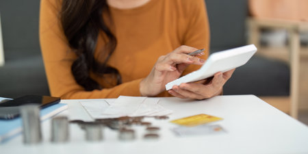 Expense Tracking and Budgeting. Woman using calculator for personal finance.