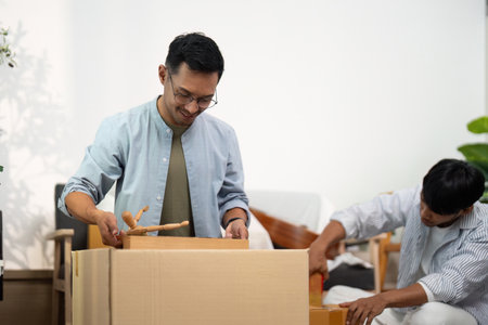 Gay couple setting up their new home with love and careの写真素材