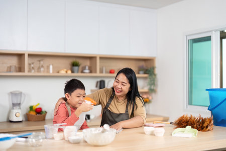 Cleaning and Baking. Engaging mother and son enjoying a fun kitchen moment.