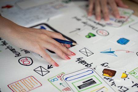 UX Design Collaboration. Hands on a brainstorming session with sketches and notes.の写真素材