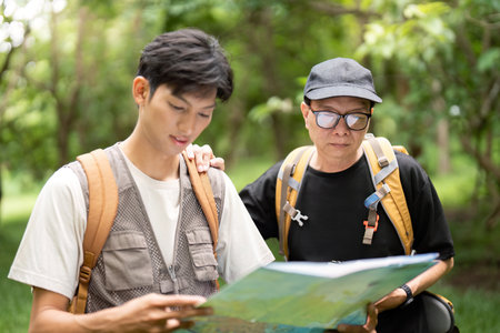 Father and Son Hiking Adventure. Exploring nature together with a map.