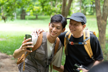 Hiking Adventure: Father and Son Taking a Selfie in Natureの写真素材