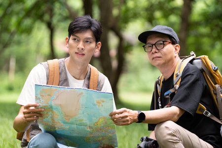 Father and Son Enjoying Hiking: Navigating with Mapの写真素材
