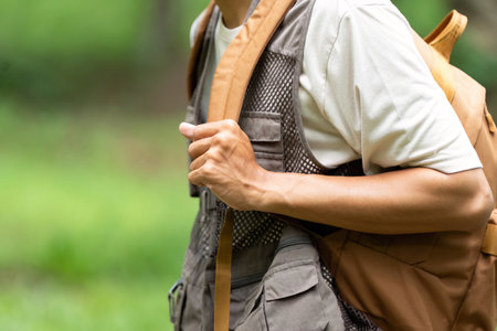 Outdoor Adventure and Eco-Friendly Lifestyle. Individual preparing for a hike with a backpack in...