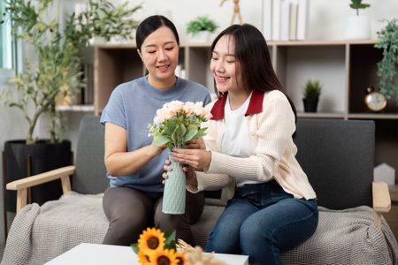Creating Beautiful Flower Bouquets Together. Mother and Daughter Sharing a Crafting Moment.の写真素材