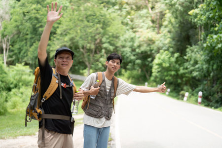 Father and Son on Hiking Trip. Two men waving and enjoying their outdoor adventure.の写真素材