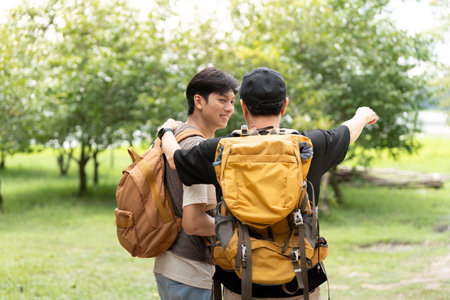Father and Son Hiking Together. A father guiding his son during an outdoor adventure.の写真素材