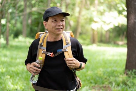 Outdoor Adventure. Hiker enjoying nature with backpack in lush green forest.