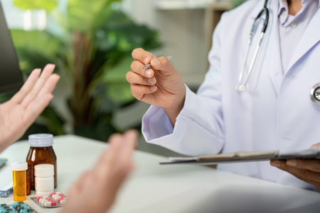 Medication Discussion. Doctor explaining prescription to patient during consultation.の写真素材