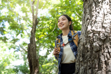 Joyful Hiking Experience. Young woman smiling while exploring a vibrant forest.
