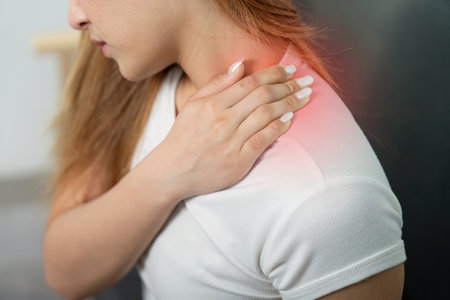 Pain Management. Woman experiencing shoulder pain at home.の写真素材