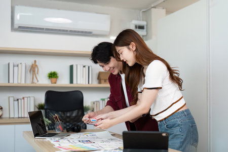 UX UI design teamwork. Young professionals discussing project ideas with sketches.の写真素材