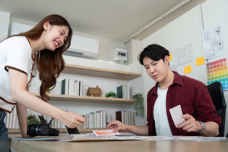 UX and UI design collaboration in a modern workspace.の写真素材