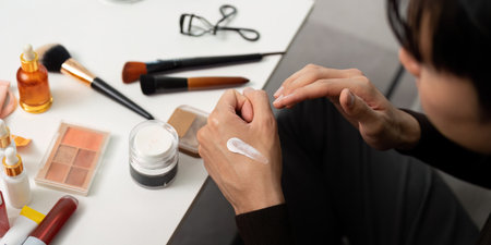 Skincare Routine. Man applying moisturizer at home with beauty products.