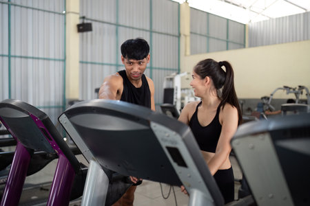 Trainer and client discussing workout progress at gym