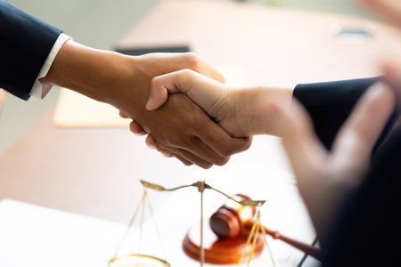 Handshake Agreement. Diverse professionals sealing a deal in a law office.の写真素材