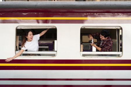Couple enjoying train travel, capturing moments together