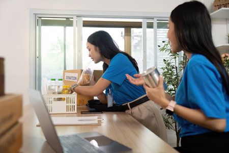 Volunteer organizing donations, showcasing teamwork and supportの写真素材