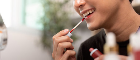 Beauty Routine: Applying Lip Gloss with a Smileの写真素材