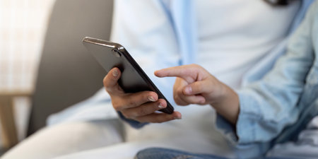 Digital Connection. Person interacting with smartphone in a cozy indoor setting.