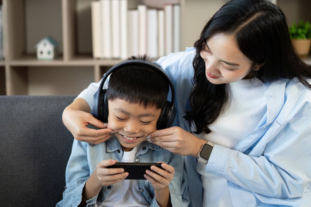 Playful Moment: Mother and Son Sharing a Laugh Over Gaming