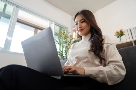 Working from Home. Young woman using laptop for remote work.の写真素材