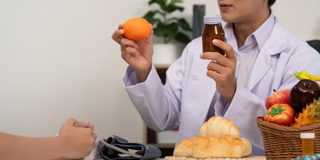 Fruit Nutrition. Doctor showcasing healthy fruit options during a patient consultation.の写真素材