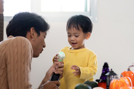 Father and child enjoying Halloween fun with toys and decorations
