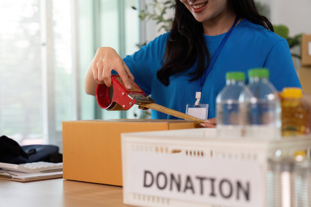 Volunteer preparing donation box, ensuring community support