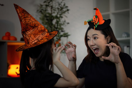 Halloween Spirit. A mother and daughter share a playful moment in spooky costumes.