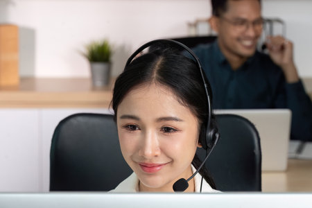 Female agent focused on customer service at her desk.