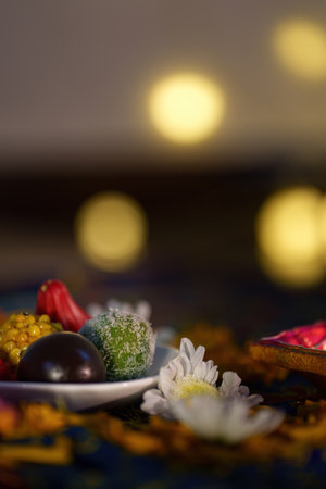 Diwali Delight: Traditional Sweets Surrounded by Diyasの写真素材