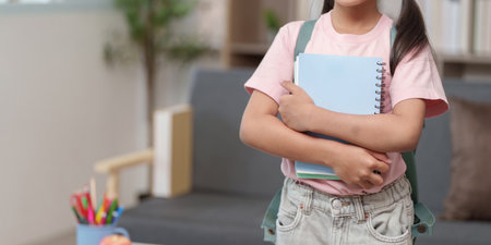 Child with notebooks ready for school at homeの写真素材