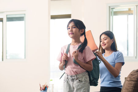 Child getting ready for school with mother helpの写真素材