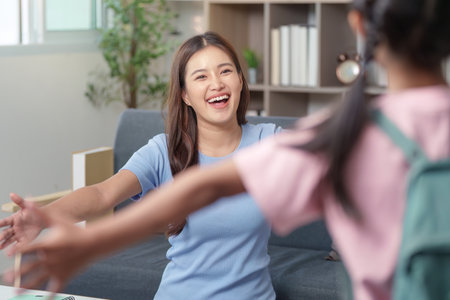 Joyful Mother welcoming child home after schoolの写真素材