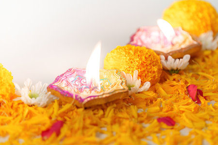 Diwali Festival. Lit oil lamps with marigold flowers and decorative petals.の写真素材