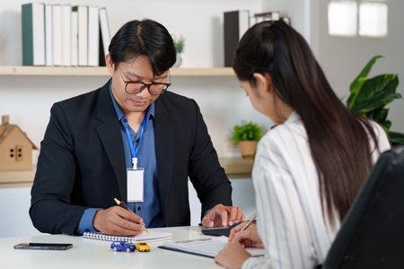 Car Insurance Consultation. Professional discussing policy details with a client.の写真素材