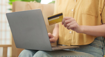 Cyber Monday Online Shopping. Woman with credit card at home using laptop.