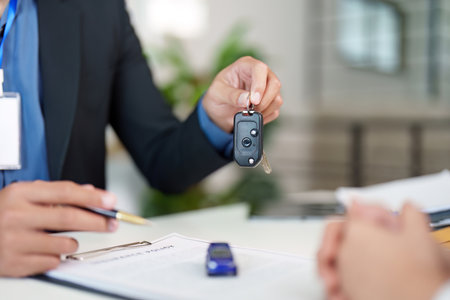 Car Key Handover. Agent presenting keys during insurance consultation.の写真素材