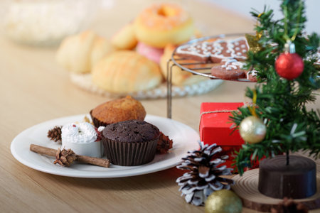 Festive Treats and Decorations. Delicious holiday desserts on a table with Christmas decor.