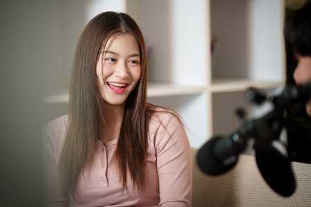 Joyful Young Woman Smiling During Podcast Discussion