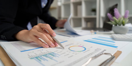 Business Analysis. Professional reviewing financial reports and charts.