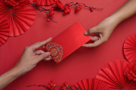 Exchanging red envelopes during Chinese New Yearの写真素材