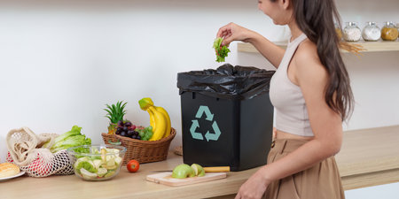 Sustainability in Action: Woman Recycling Food Waste in Kitchenの写真素材