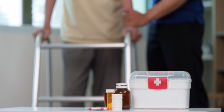 Caregiver assisting elderly patient with mobility using walkerの写真素材