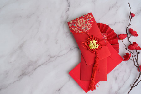 Chinese New Year red envelopes with decorative tassel and flowersの写真素材