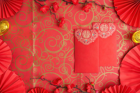 Chinese New Year red envelopes and decorations on ornate backgroundの写真素材