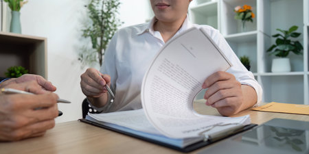 Document Review. Professional analyzing paperwork during a business meeting.